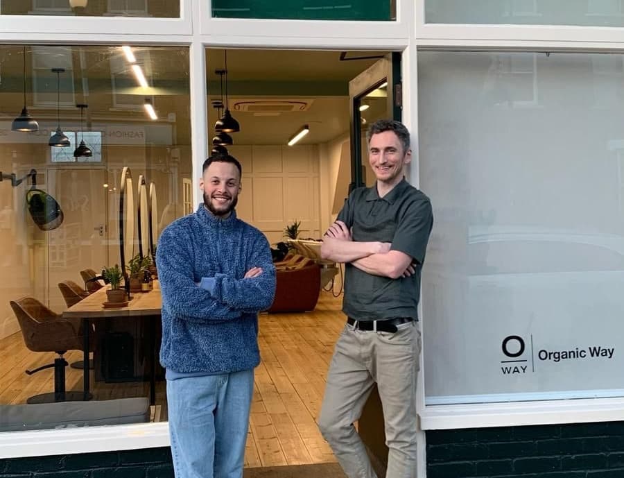 Jonny and Gab standing outside shop